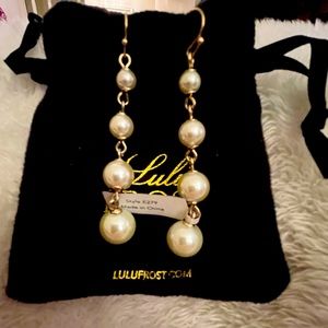 Lulu Frost dangling pearl earrings.
